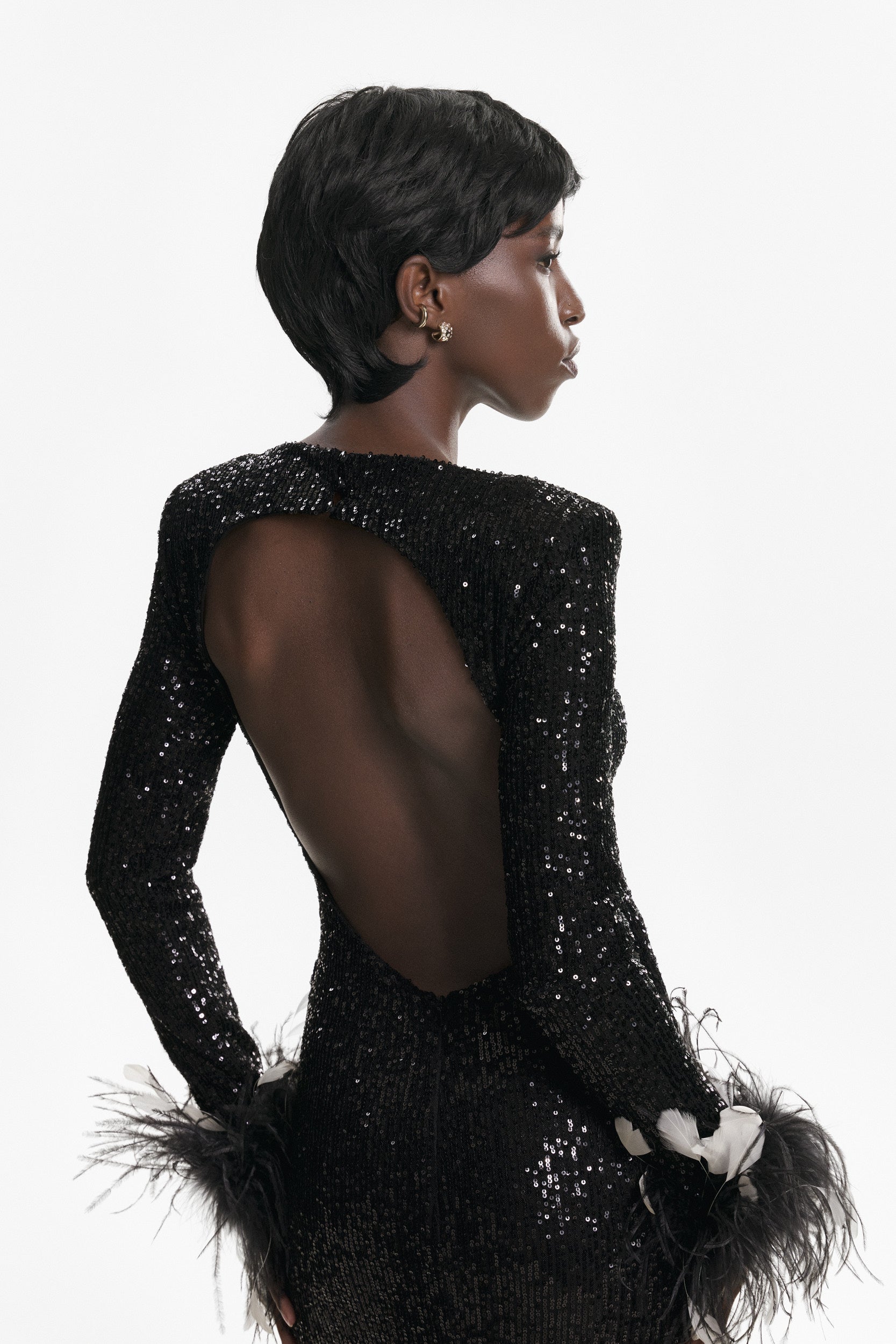 Open-back sequins dress with feathers