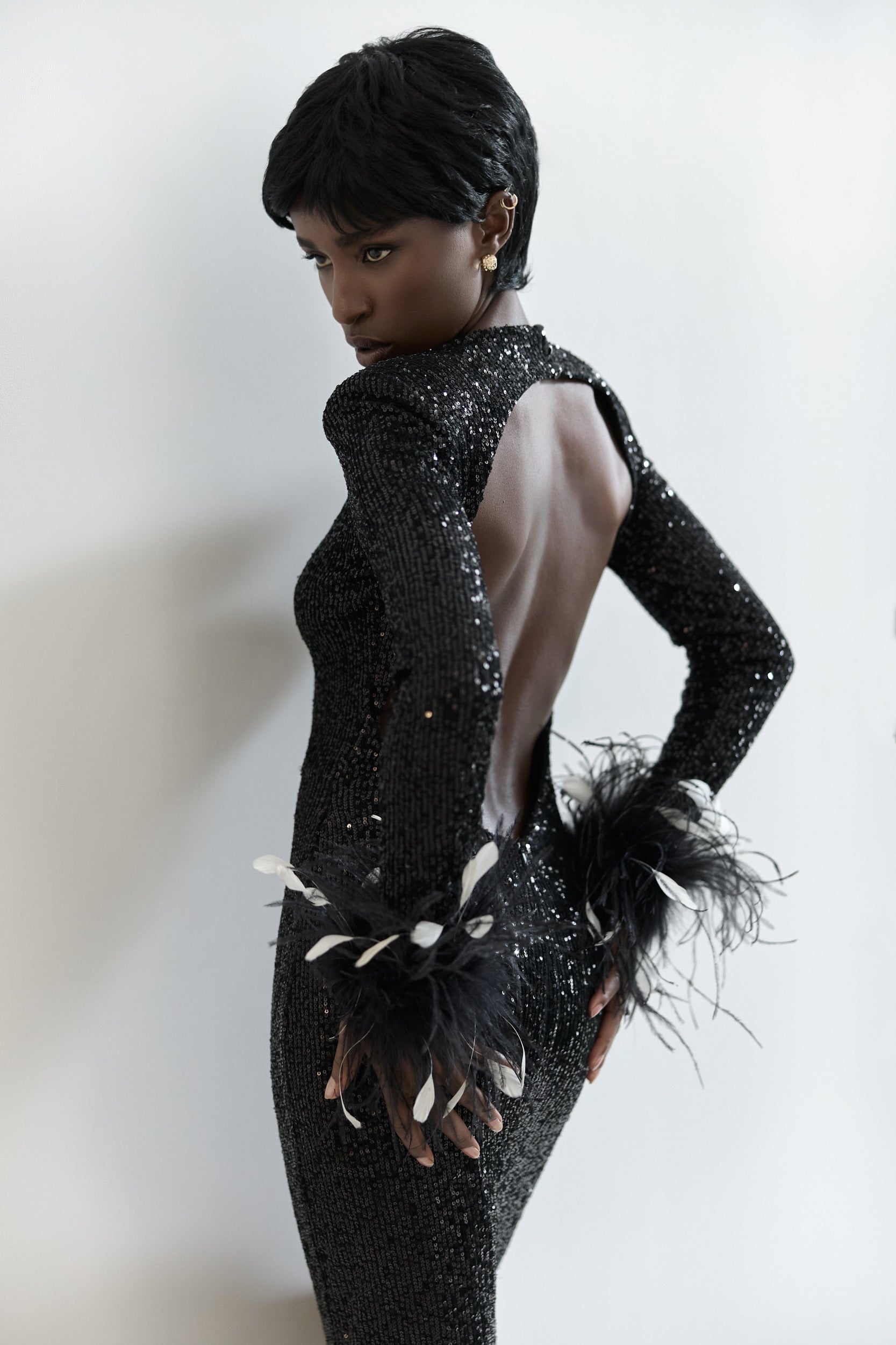 Open-back sequins dress with feathers