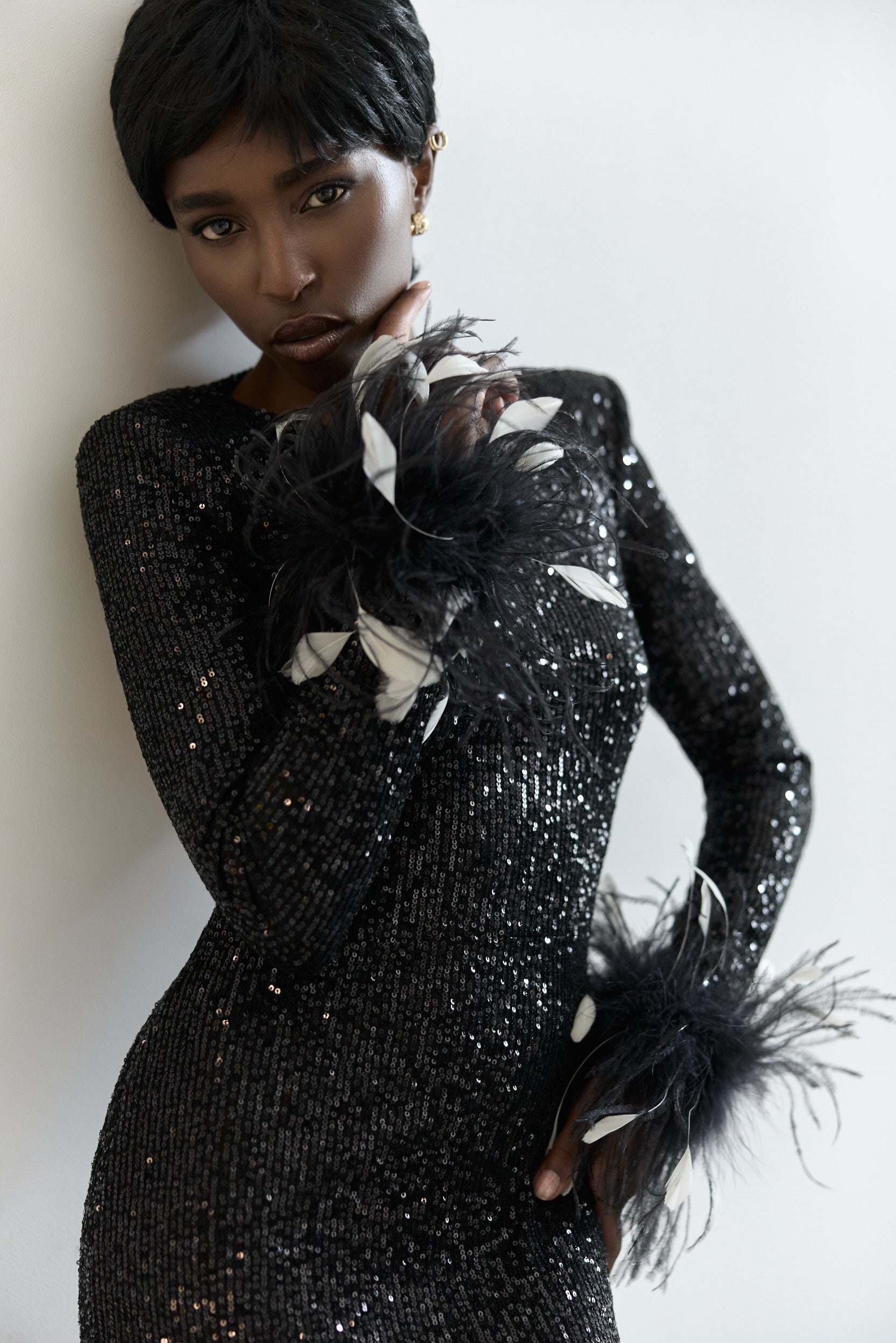 Open-back sequins dress with feathers