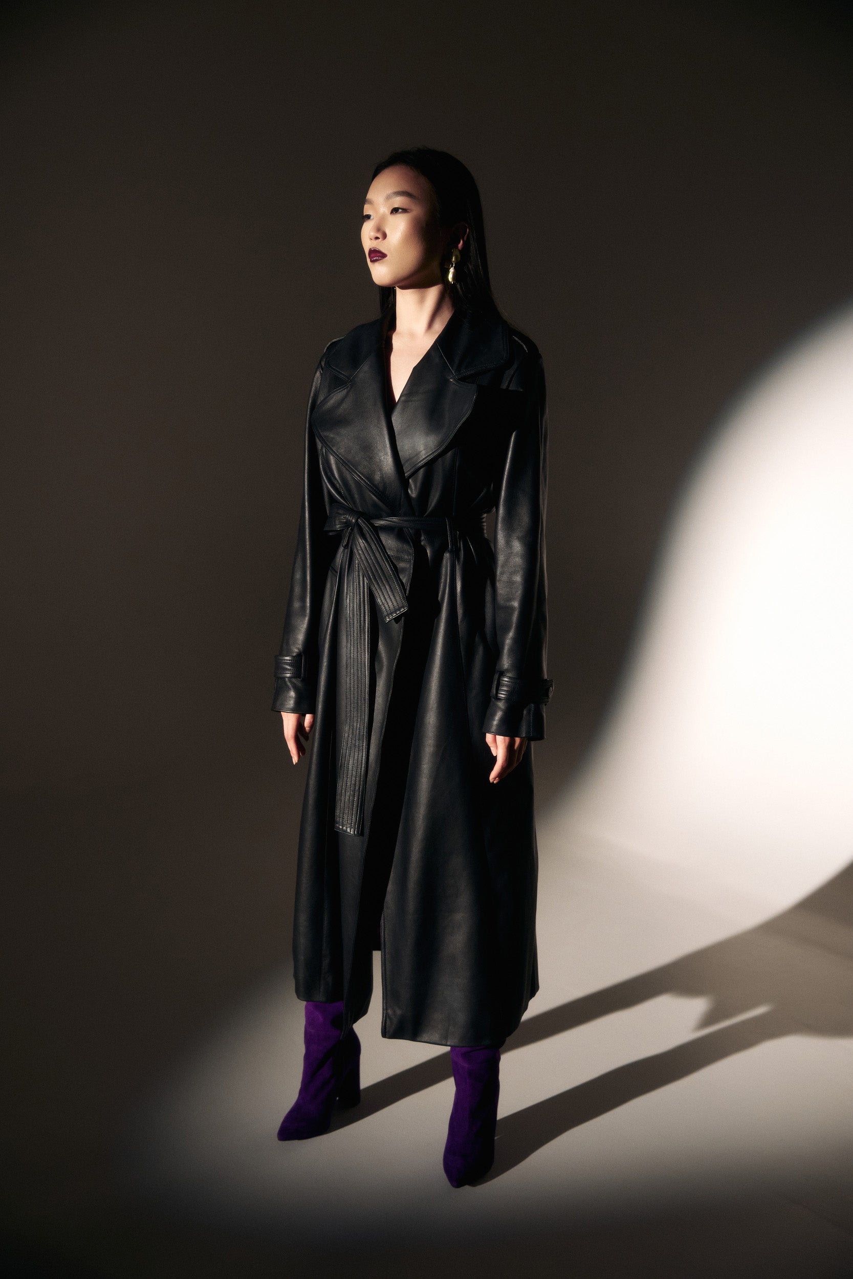 Belted leather trench coat in black