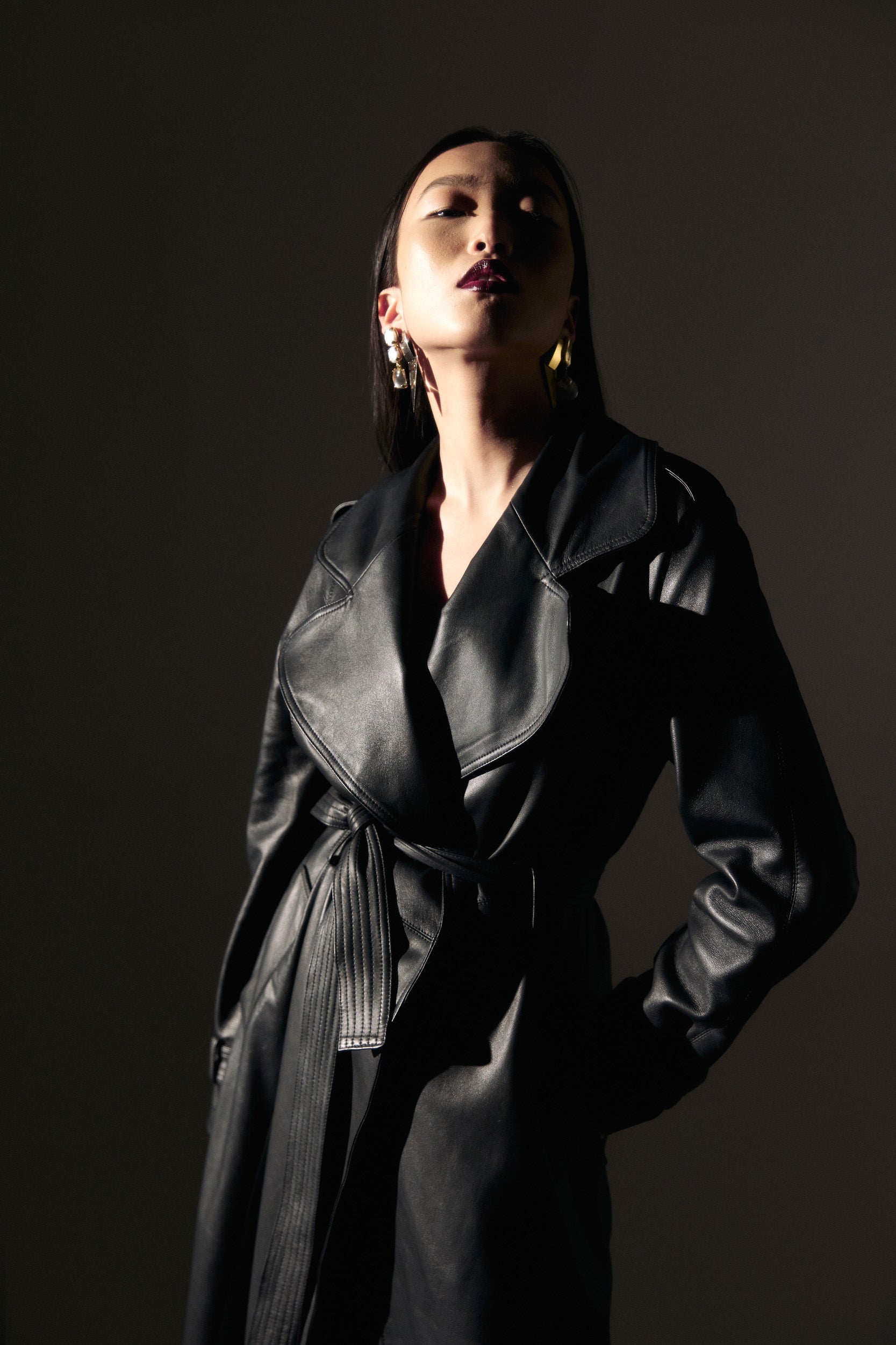 Belted leather trench coat in black