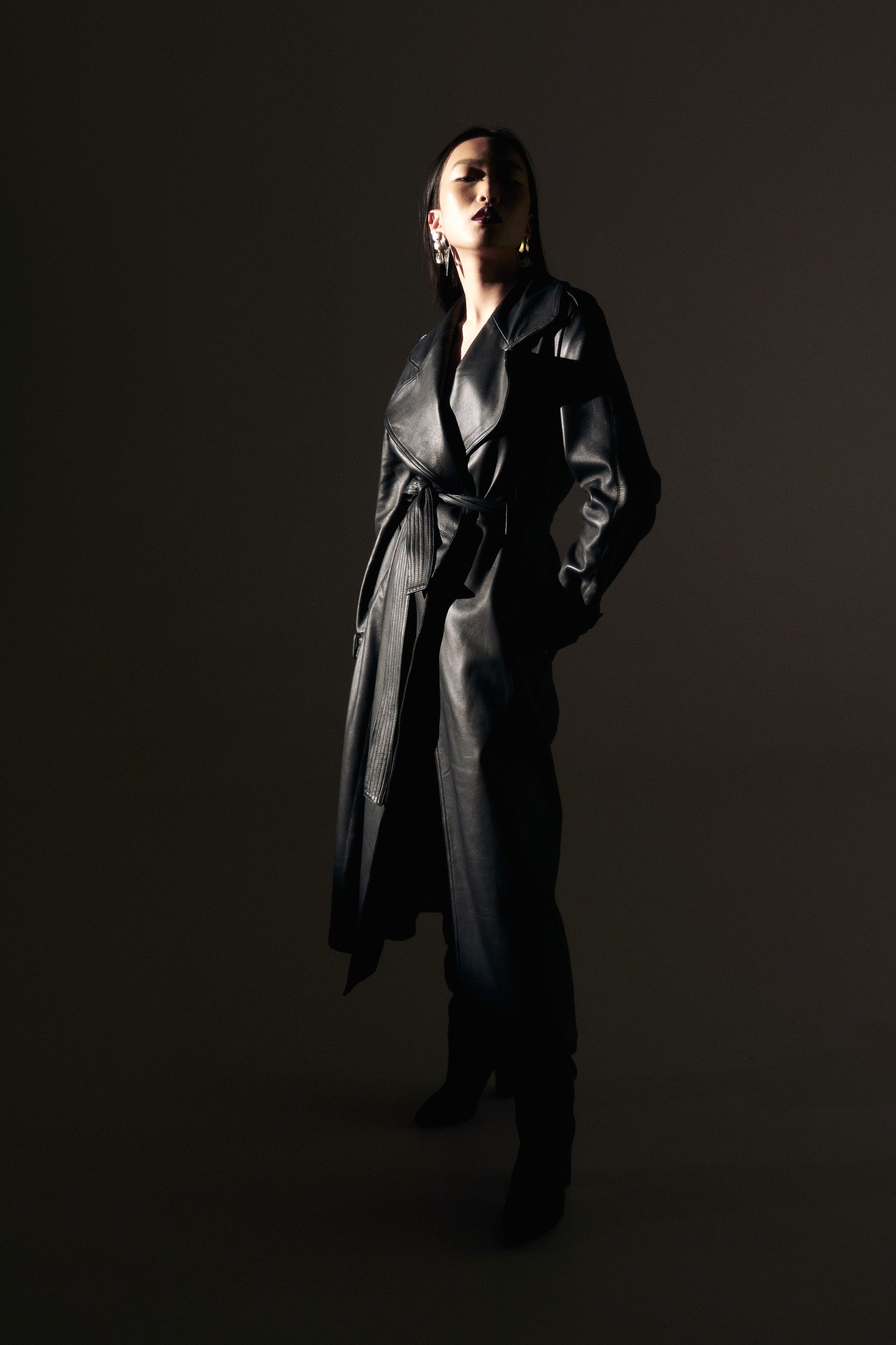 Belted leather trench coat in black
