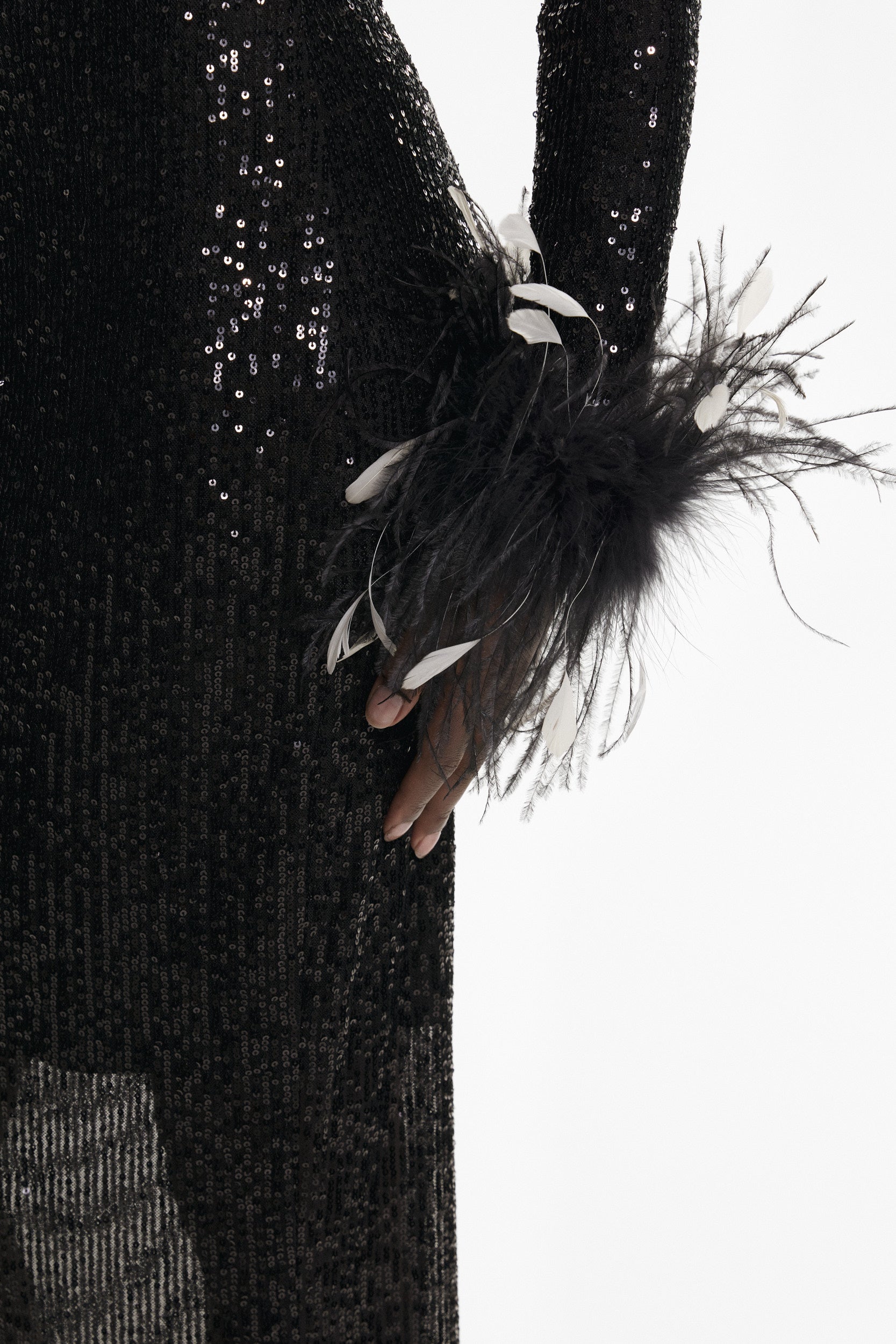 Open-back sequins dress with feathers